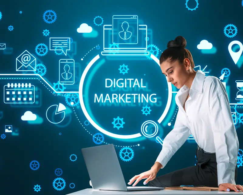 Professional woman working on a laptop surrounded by digital marketing icons, analytics symbols, and online communication graphics representing a career in digital marketing.